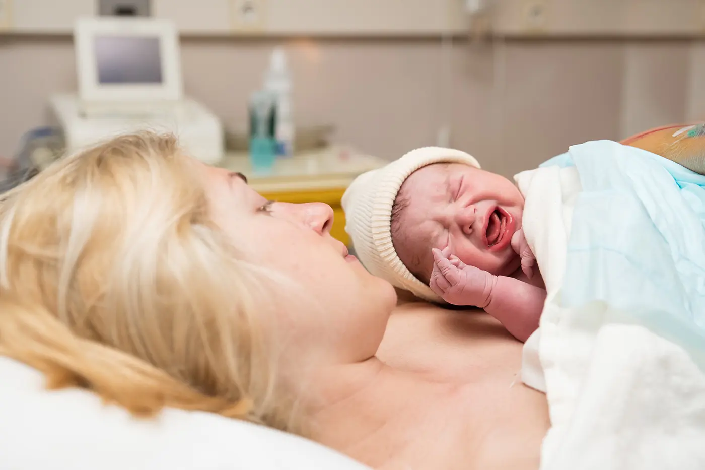 A mother holds her newborn skin-to-skin after birth — the kind of moment a birth plan protects